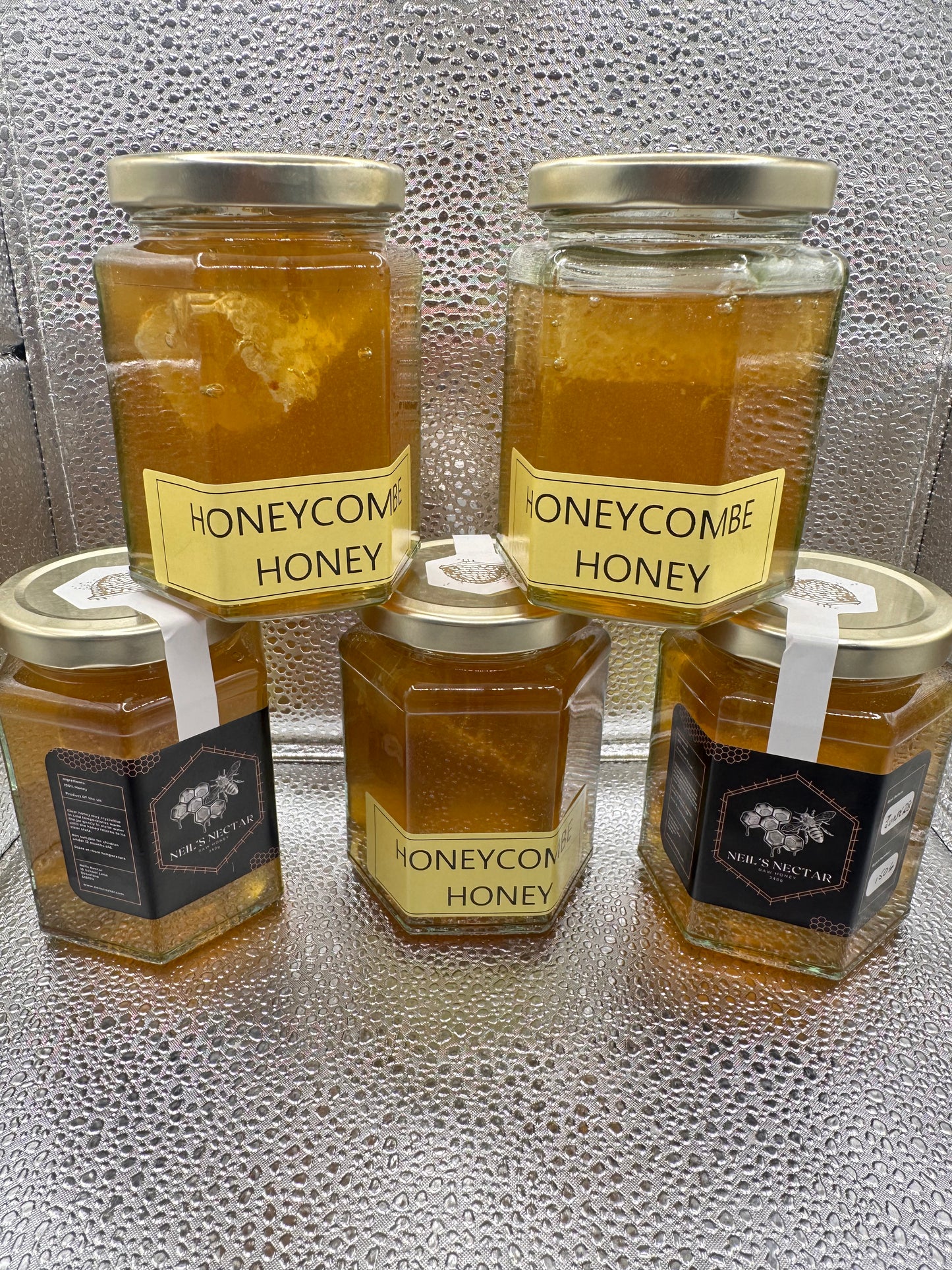 Neil's Nectar Honey 340g Jar with a natural piece of honeycomb within