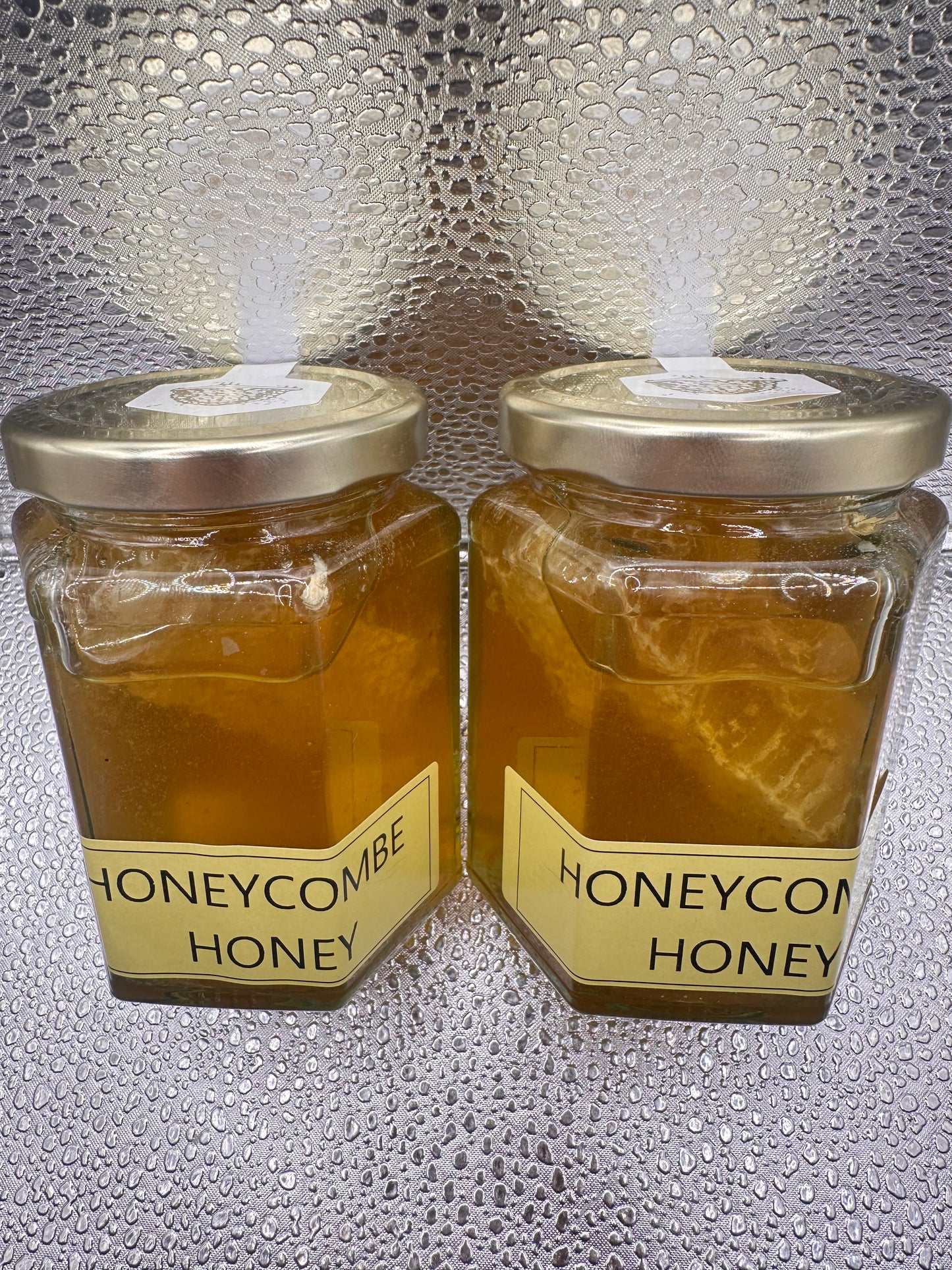Neil's Nectar Honey 340g Jar with a natural piece of honeycomb within