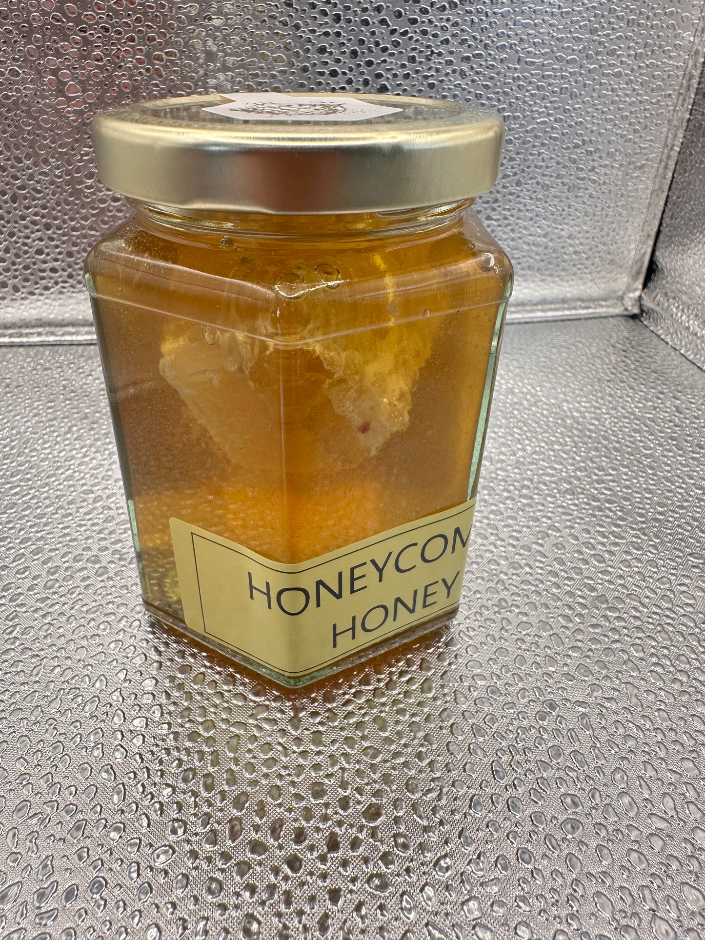 Neil's Nectar Honey 340g Jar with a natural piece of honeycomb within